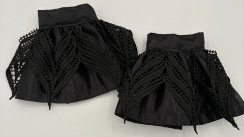 A pair of black pleated satin and lace cuffs meant to be worn under a jacket, blouse or sweater.