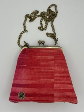 A small red striped clutch purse with a gold-tone metal frame and a matching chain strap, shown on a plain white background.