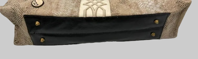 A rectangular shoulder bag with a beige snakeskin pattern, a central cream-colored textured panel with geometric detailing, and black leather handles and bottom trim with brass-tone studs.