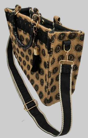 A small shoulder bag with a beige and black leopard print pattern, featuring a wide black strap with beige trim and gold-tone hardware, photographed on a white background.