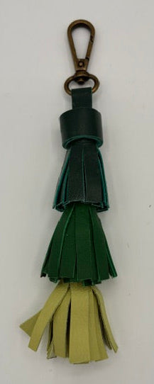 A leather tassel keychain with a dark green body, a light olive green fringe, and a dark metal lobster clasp, shown on a plain white background.